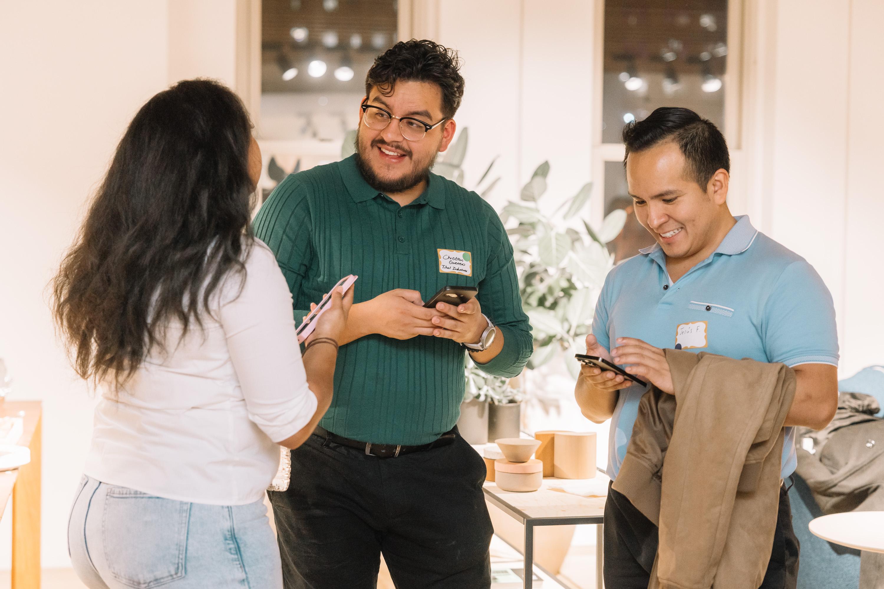 Professionals exchanging contacts at a Hispanic Heritage Month networking event.